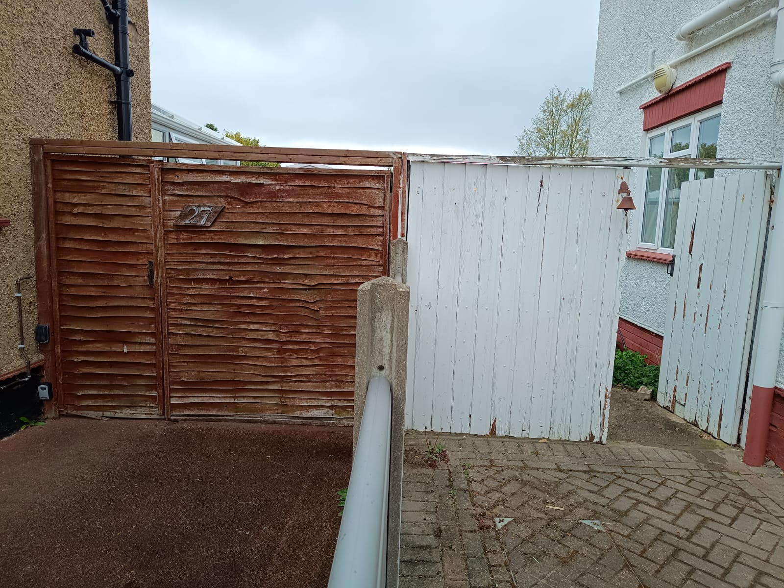 Old worn painted wooden gates before replacement