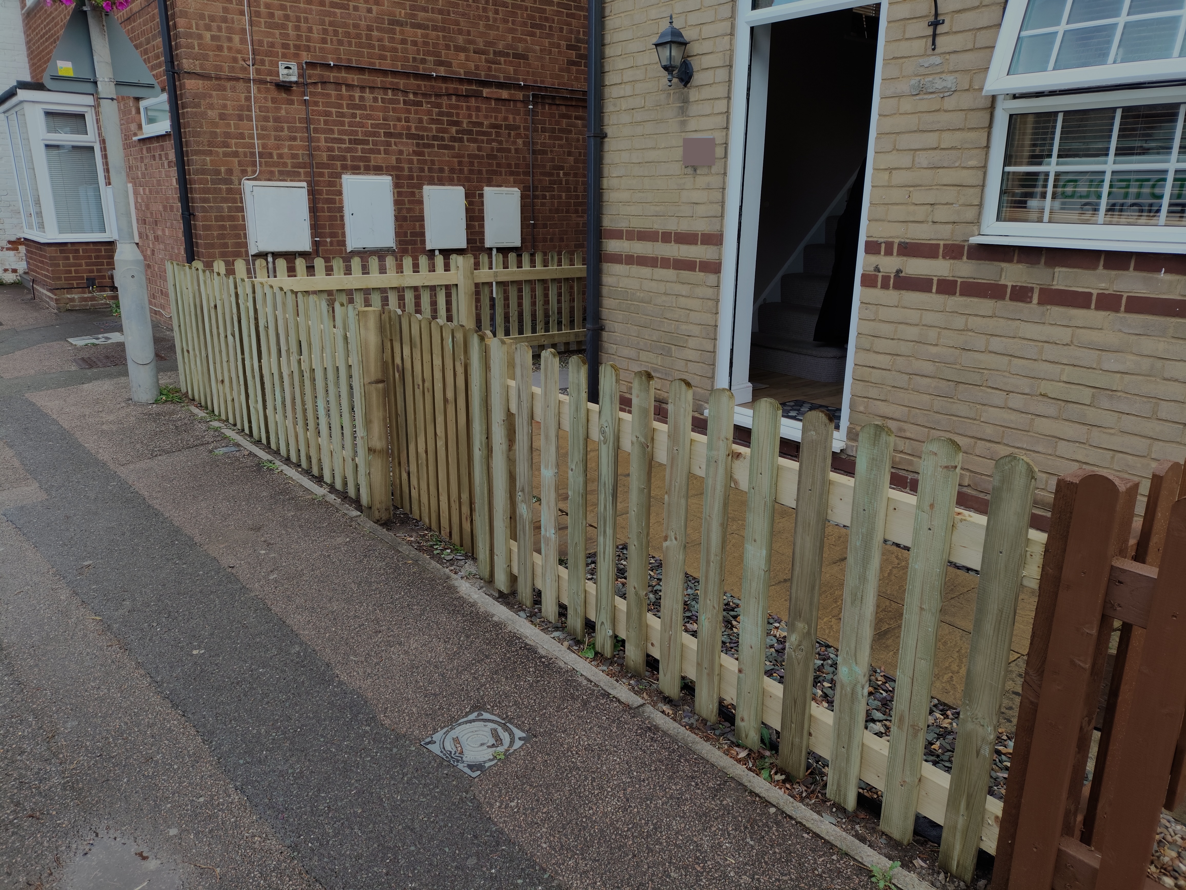New picket fence and gate to a front garden, side angle